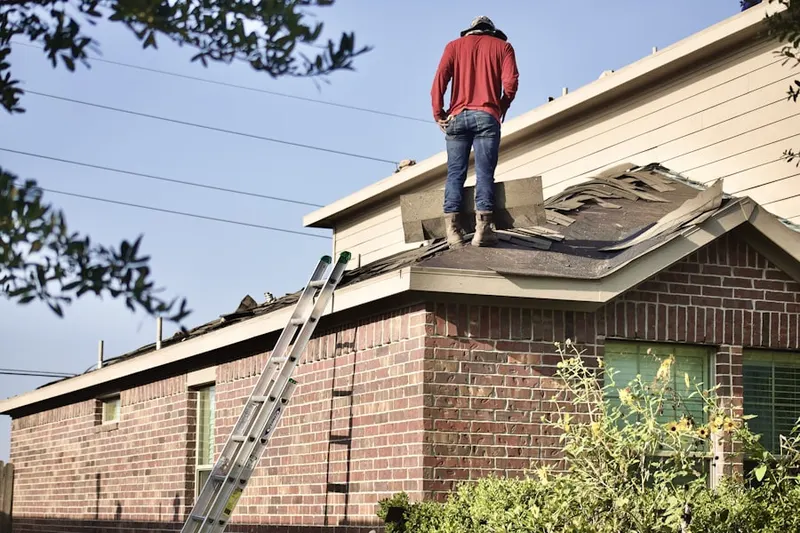 Professional roofer working on a residential roof in Stansbury Park